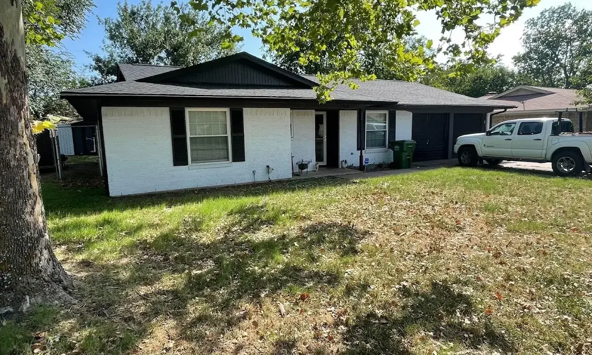 Professional roofing crew working on a residential roof in Patton